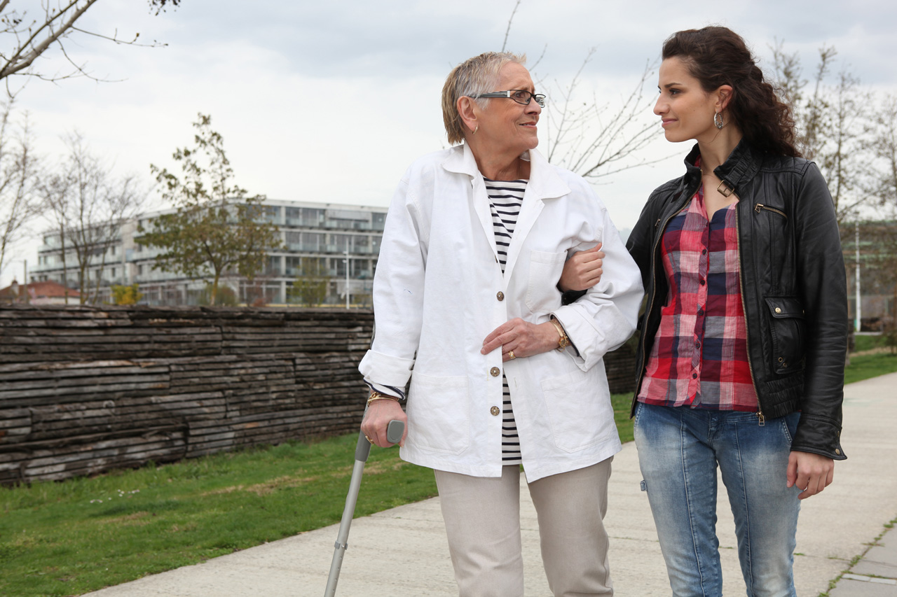 woman-strolling-with-an-elderly-lady